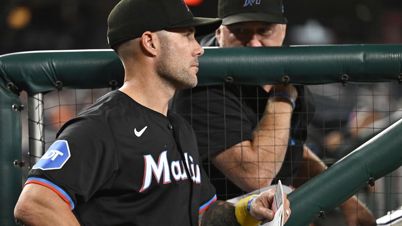 Miami Marlins manager Skip Schumaker, left, listens to Marlins pitching coach Mel Stottlemyre, right, in the dugout during the sixth inning of a baseball game against the Washington Nationals, Thursday, Sept. 12, 2024, in Washington. (AP Photo/John McDonnell)