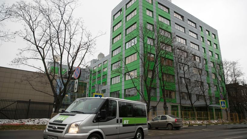 FILE - A car of Russian state-owned television station RT passes by the company's office on Oct. 27, 2017, in Moscow. (AP Photo/Pavel Golovkin, File)