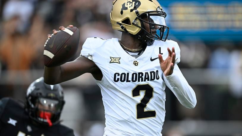 Colorado quarterback Shedeur Sanders (2) throws a pass as Central Florida defensive back Braeden Marshall (4) defends during the first half of an NCAA college football game, Saturday, Sept. 28, 2024, in Orlando, Fla. (AP Photo/Phelan M. Ebenhack)