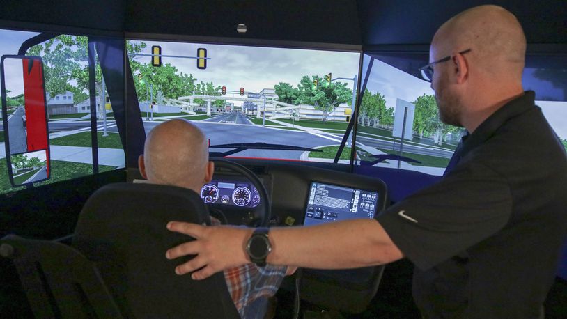 Dan Keller, manager of field engineering for L3Harris Technologies with a student in the TranSim 7-Series Driver Training Simulator, which Clark State College purchased for its CDL and emergency services programs. Contributed/L3Harris Technologies