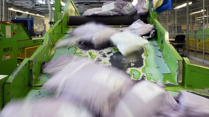 FILE - Parcels slide down a ramp after being scanned at the U.S. Customs and Border Protection overseas mail inspection facility at Chicago's O'Hare International Airport Feb. 23, 2024, in Chicago. (AP Photo/Charles Rex Arbogast, File)