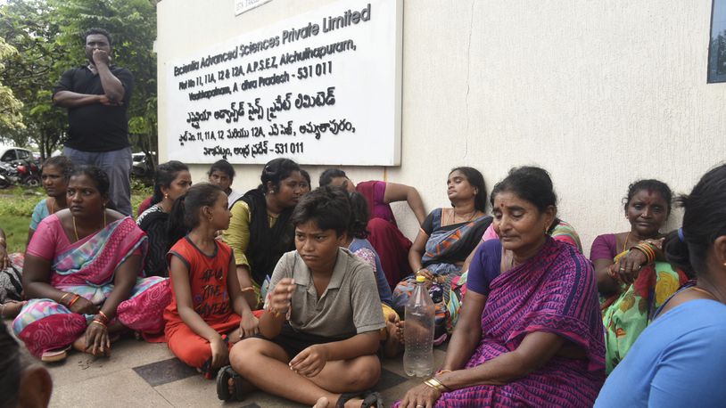 Relatives of the victims killed in a fire triggered by an explosion at the Escientia Advanced Sciences Private Ltd., a pharmaceutical company, sit outside the factory, in Atchutapuram, Andhra Pradesh state, India, Thursday, Aug. 22, 2024. (AP Photo)