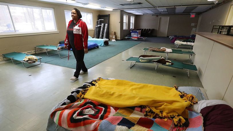 Larina Bias, program manager at Interfaith Hospitality Network, walks through overflow sleeping room at the Network’s Family Shelter in 2019. Since the coronavirus pandemic, there has been a 47% increase in the demand for emergency shelter services. Bill Lackey/Staff