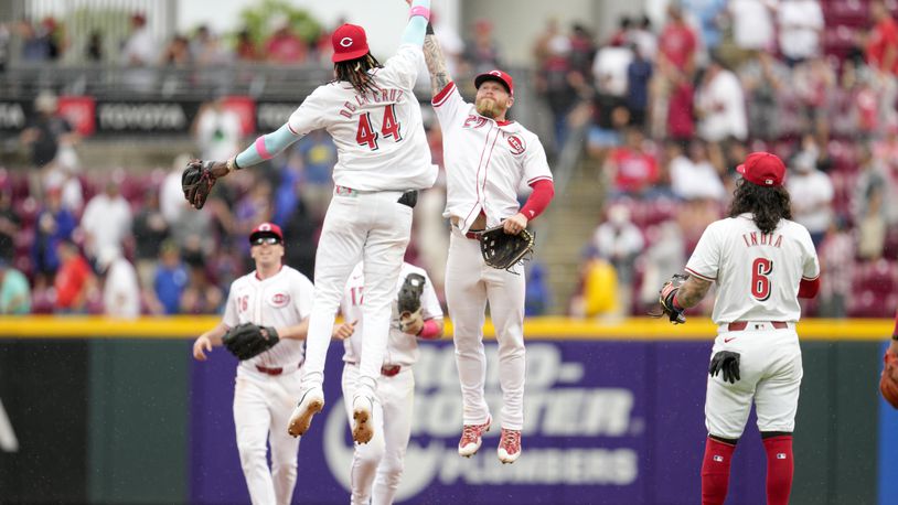 Cincinnati Reds' Elly De La Cruz (44) celebrates with Jake Fraley (27) after the Reds defeated the Los Angeles Dodgers in a baseball game, Sunday, May 26, 2024, in Cincinnati. (AP Photo/Jeff Dean)