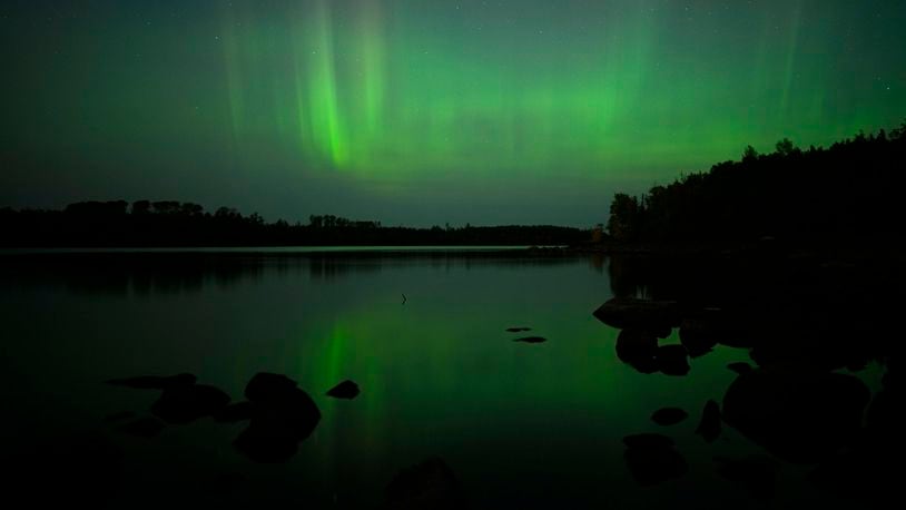 The northern lights, or aurora borealis, are visible in the sky north of the Fall Lake Campground Thursday, Sept. 12, 2024 just outside the Boundary Waters Canoe Area Wilderness in Ely, Minn. (Aaron Lavinsky/Star Tribune via AP)