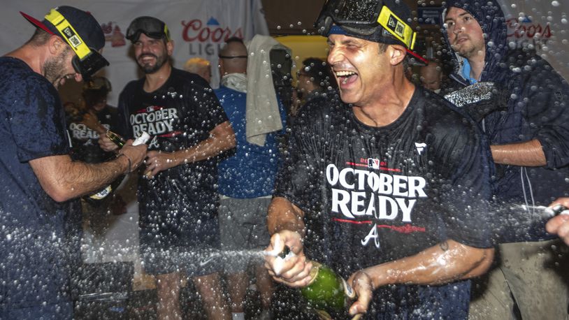 The Atlanta Braves celebrate in the locker room after clinching a wild-card playoff berth after the second baseball game of a doubleheader against the New York Mets, Monday, Sept. 30, 2024, in Atlanta. (AP Photo/Jason Allen)