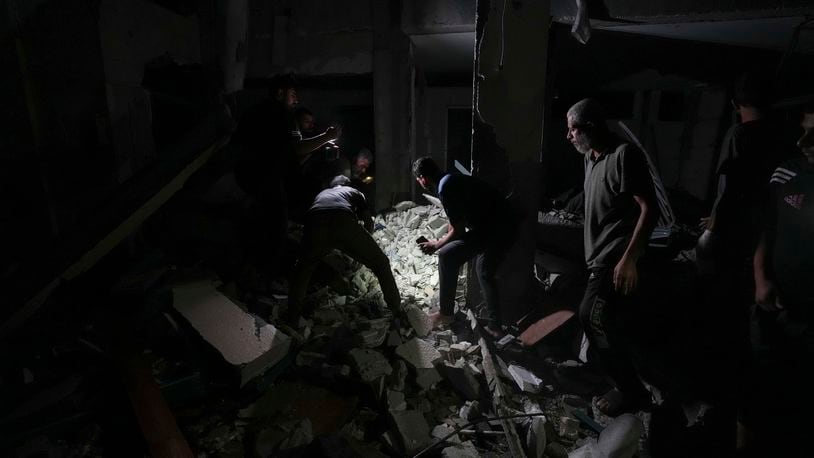 Palestinians search for survivors and bodies in the rubble of a mosque destroyed in an Israeli airstrike in Deir al-Balah, Sunday, Oct. 6, 2024. (AP Photo/Abdel Kareem Hana)