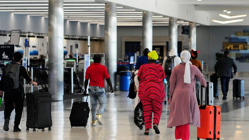 Travelers walk through Dayton International Airport Thursday, June 27, 2024. The airport will be busy for Independence Day week as travel nationwide is expected to be 5% greater than in 2023 and 8% greater than 2019. MARSHALL GORBY/STAFF