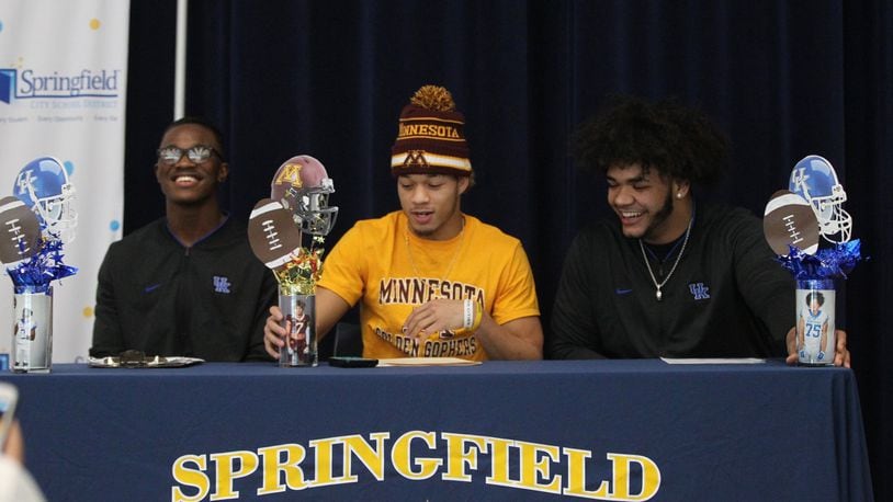 Springfield football players (left to right) Moses Douglass, Michael Brown-Stephens and Isaiah Gibson appear at a signing day ceremony at the high school on Wednesday, Dec. 19, 2018, in Springfield. David Jablonski/Staff