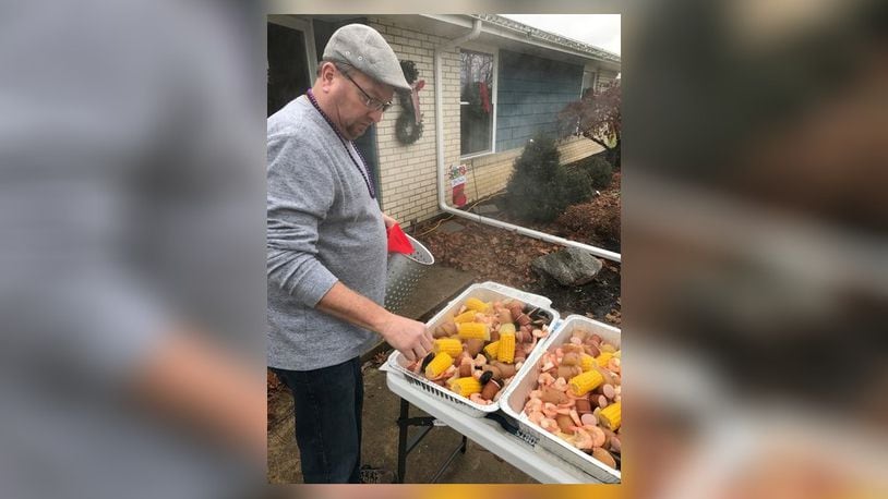 Writer Ben McLaughlin says his untraditional Christmas dinner tradition spans more than 30 years with his in-laws, including his brother-in-law, Scott Cramer, shown here tending to a seafood boil in 2016 for a Mardi Gras theme. Other memorable themes have included food popular at sporting events, a bacon night in which all dishes had to include bacon, and a birthday meal night made of dishes popular in the year of your birth. CONTRIBUTED