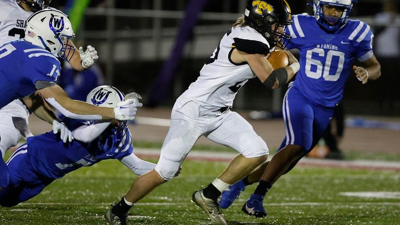 TJ Meeks breaks through the Wyoming defense and runs for a touchdown during Friday's playoff game. BILL LACKEY/STAFF