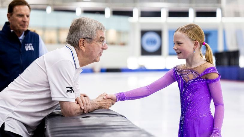 International Olympic Committee President Thomas Bach shakes hands with figure skater Annabelle Atkinson, 10, of Salt Lake City, as they talk at the Utah Olympic Oval in Kearns, Utah, Saturday, Sept. 28. 2024. (Isaac Hale/The Deseret News via AP)