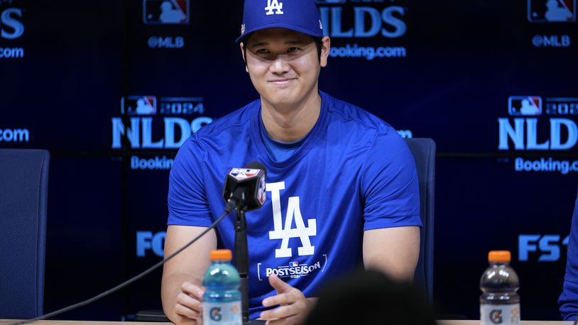 Los Angeles Dodgers' Shohei Ohtani speaks to reporters in a press conference in preparation for Game 1 of a baseball NL Division Series against the San Diego Padres in Los Angeles, Friday, Oct. 4, 2024. (AP Photo/Ashley Landis)