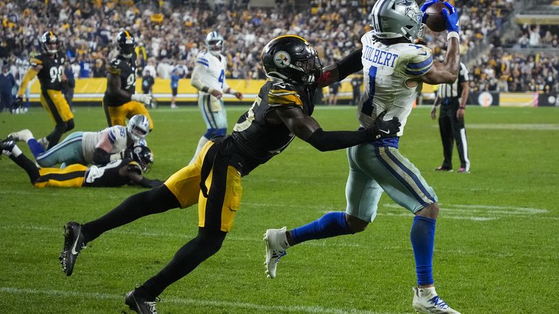 Dallas Cowboys wide receiver Jalen Tolbert (1) makes a touchdown catch as Pittsburgh Steelers safety DeShon Elliott tries to stop him during the second half of an NFL football game, early Monday, Oct. 7, 2024, in Pittsburgh. The Cowboys won 20-17. (AP Photo/Gene J. Puskar)