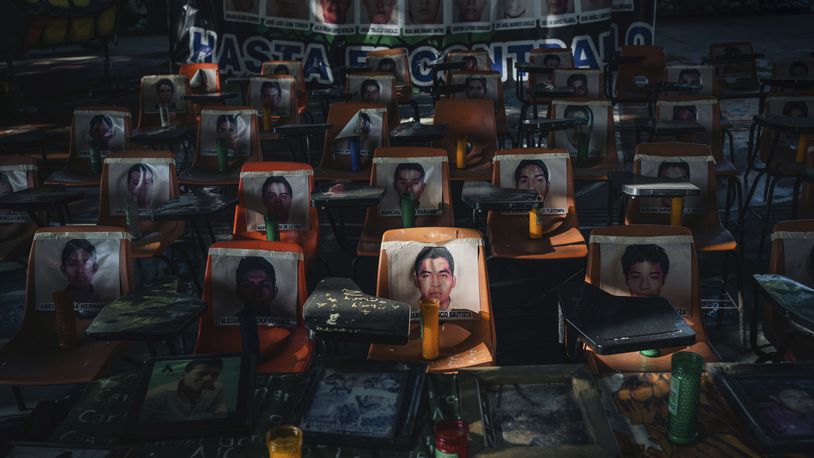 Photos of 43 students who have been missing for 10 years cover the stairs at their former Raúl Isidro Burgos Rural Normal School in Ayotzinapa, Guerrero state, Mexico, Saturday, Aug. 24, 2024. (AP Photo/Felix Marquez)