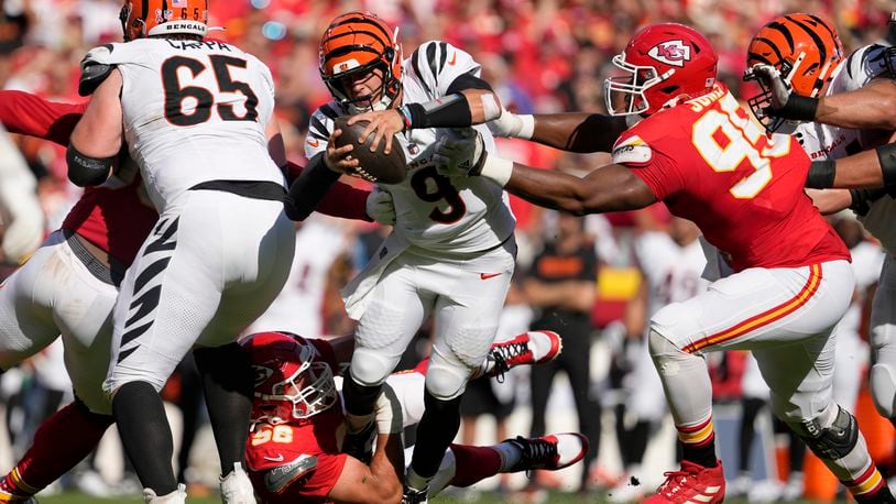 Cincinnati Bengals quarterback Joe Burrow (9) struggles for yardage as Kansas City Chiefs defensive tackle Chris Jones (95) and defensive end George Karlaftis (56) defend during the first half of an NFL football game Sunday, Sept. 15, 2024, in Kansas City, Mo. (AP Photo/Ed Zurga)