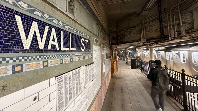 Passengers leave a train at the Wall St. subway station in New York's Financial District on Wednesday, Oct. 9, 2024. (AP Photo/Peter Morgan)