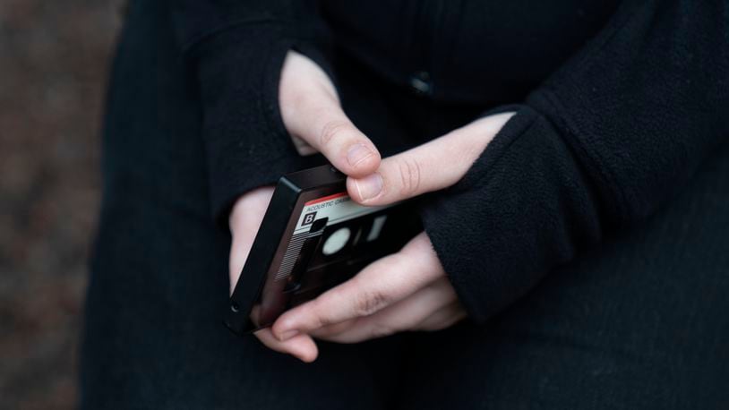 Amelia, 16, holds her phone as she sits for a portrait in a park near her home in Illinois, on Friday, March 24, 2023. She had depression that was exacerbated during the pandemic and received help at a children's hospital. “We are trying to survive in a world that is out to get us," Amelia says. (AP Photo Erin Hooley)