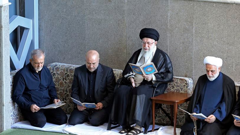 In this photo released by the official website of the office of the Iranian supreme leader, Supreme Leader Ayatollah Ali Khamenei, second right, Judiciary Chief Gholam Hossein Mohseni Ejehei, right, Parliament Speaker Mohammad Bagher Qalibaf, second left, and President Masoud Pezeshkian read Quran in a ceremony commemorating slain Hezbollah leader Hassan Nasrallah, at Imam Khomeini grand mosque in Tehran, Iran, Friday, Oct. 4, 2024. (Office of the Iranian Supreme Leader via AP)