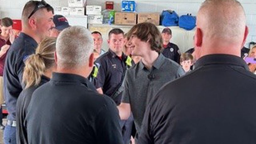 In January, Aiden Williamson, 16, a junior at Warren County Career Center, suffered a cardiac arrest while in school. He credits several medical personnel for saving his life. On Friday, Aiden presented Challenge Coins during a ceremony at Clearcreek Twp. Fire Station 21. RICK McCRABB/CONTRIBUTED