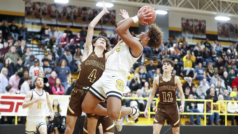 Shawnee High School junior Darian Dixon drives to the hoop while being defended by Kenton Ridge junior Canye Rogan during their game on Friday, Jan. 27 at Shawnee High School. The Braves won 50-38. Michael Cooper/CONTRIBUTED