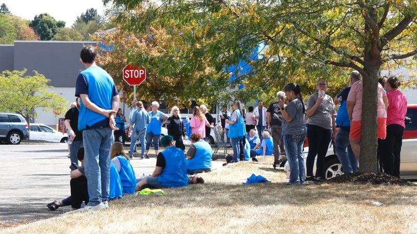 Walmart employees wait in the parking lot after the Bechtle Avenue store was evacuated due to a threat Wednesday, Sept. 18, 2024. BILL LACKEY/STAFF