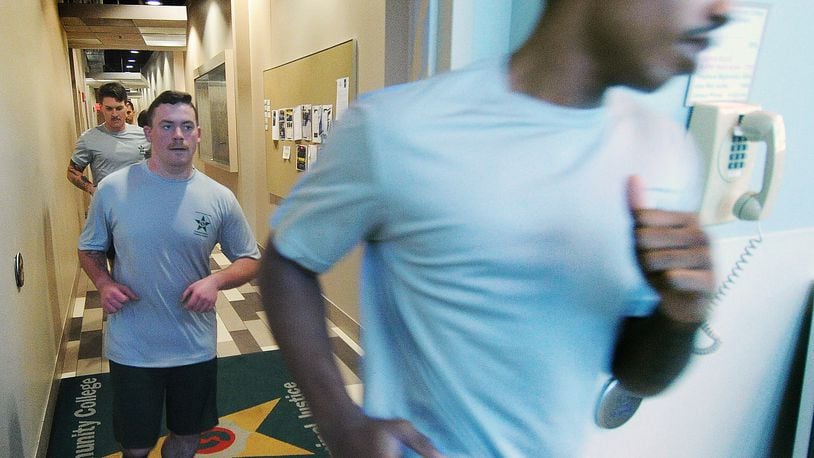 Police cadets run a circuit through the halls at Sinclair Community College, Thursday, Jan. 11, 2024. MARSHALL GORBY\STAFF