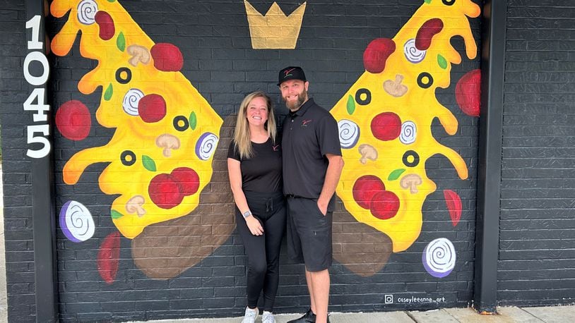 Owners Ashley and Mike Estep pose in front of a mural at their restaurant The Villa Pizzeria on Friday, Sept. 2, 2023. JESSICA OROZCO/STAFF
