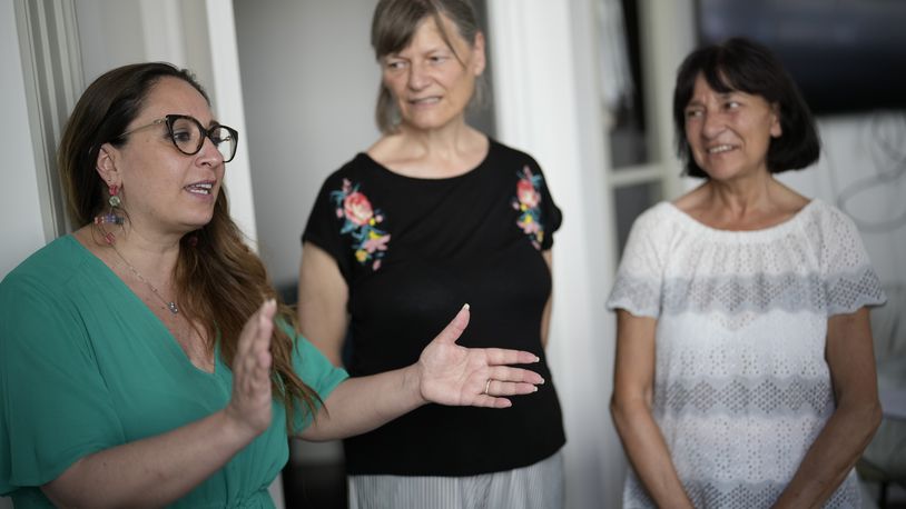 Lawyer Laura Sgro', left, talks to Mirjam Kovac, center, and Gloria Branciani, as they arrive for an interview with the Associated Press, in Rome, Friday, June 28, 2024. Kovac and Branciani are two of five women who urged Catholic bishops around the world to remove from their churches mosaics by ex-Jesuit artist Rev. Marko Rupnik after they accused him of psychologically, spiritually and sexually abusing them. (AP Photo/Andrew Medichini)