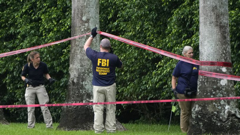 Law enforcement officials work at the scene of the Trump International Golf Club in the aftermath of the apparent assassination attempt of Republican presidential nominee and former President Donald Trump Tuesday, Sept. 17, 2024, in West Palm Beach, Fla. (AP Photo/Lynne Sladky)