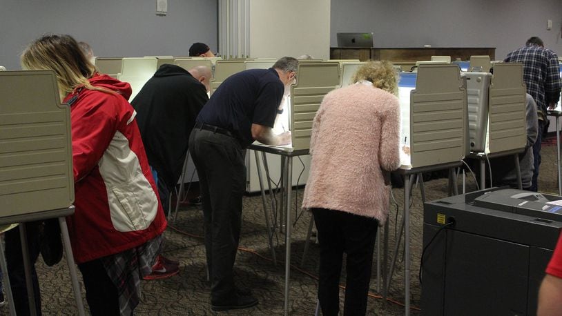 Voters cast their votes at the First Christian Church on Middle Urbana Road on Tuesday. Eric Higgenbotham/STAFF