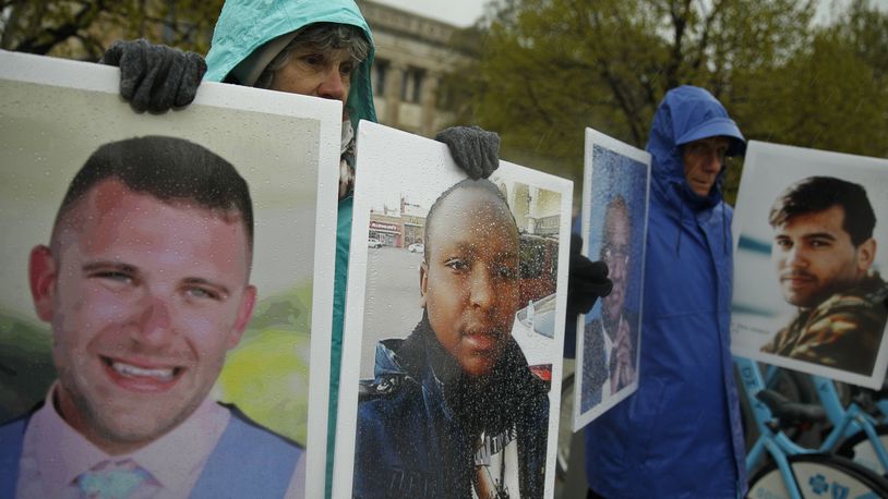 FILE - Protesters hold the photographs of victims, including Melvin Riffel, left, of the Ethiopian Airlines plane crash, outside Boeing's annual shareholders meeting in Chicago on April 29, 2019. Ike Riffel , a California father whose two sons died in the 2019 crash, fears that instead of putting Boeing on trial, the government will offer the company another shot at corporate probation through a legal document called a deferred prosecution agreement, or DPA. (AP Photo/Jim Young, File)