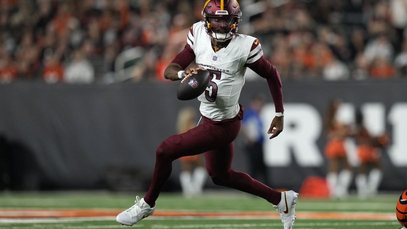 Washington Commanders quarterback Jayden Daniels (5) runs up field during the second half of an NFL football game against the Cincinnati Bengals, Monday, Sept. 23, 2024, in Cincinnati. (AP Photo/Carolyn Kaster)