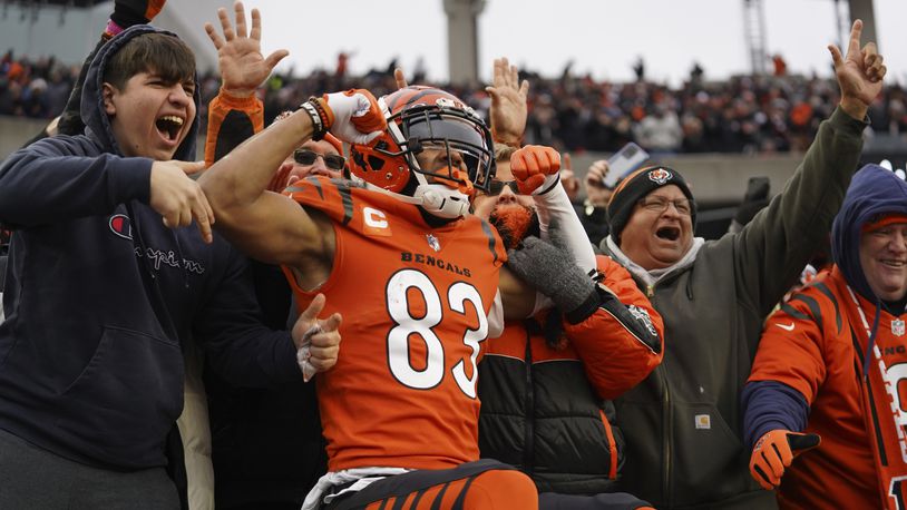Cincinnati Bengals wide receiver Tyler Boyd (83) celebrates a 5-yard touchdown with fans during the second half of an NFL football game against the Kansas City Chiefs, Sunday, Jan. 2, 2022, in Cincinnati. (AP Photo/Jeff Dean)