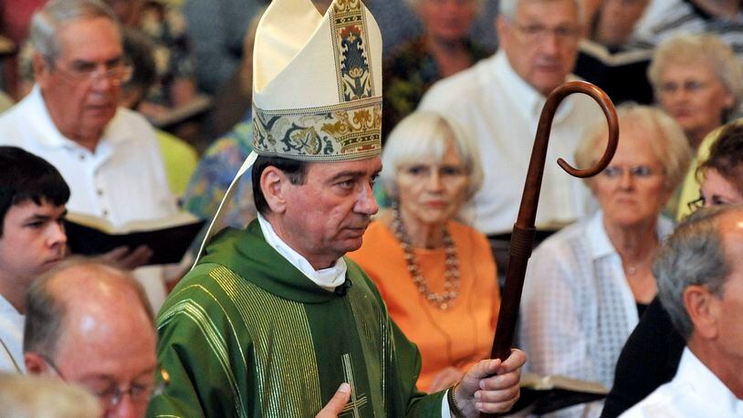 Archbishop Dennis Schnurr walks with the processional during the start of mass. Staff photo by Bill Lackey