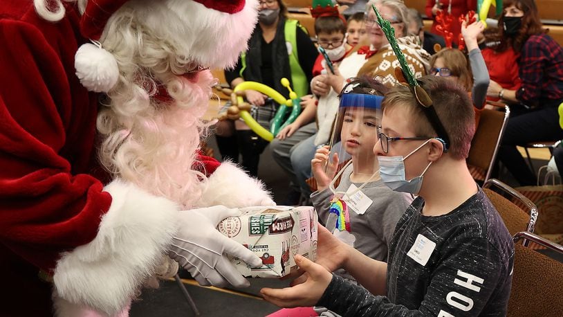 Dozens of children throughout Clark County got to have some holiday fun and meet Santa during the annual Springfield Rotary Club's Christmas Party for Children with Disabilities Monday at Wittenberg University. BILL LACKEY/STAFF