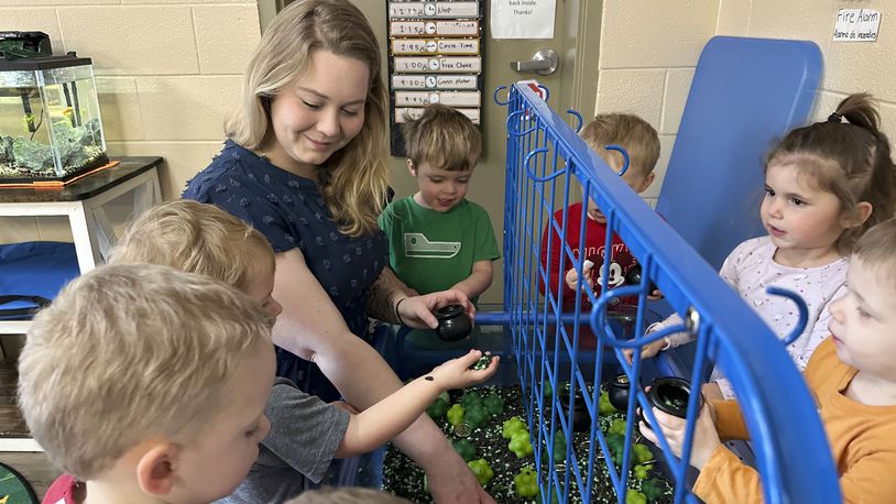 FILE - Rylee Monn plays with children in her class at a child care center in Lexington, Ky., March 13, 2024. (AP Photo/Dylan Lovan, File)