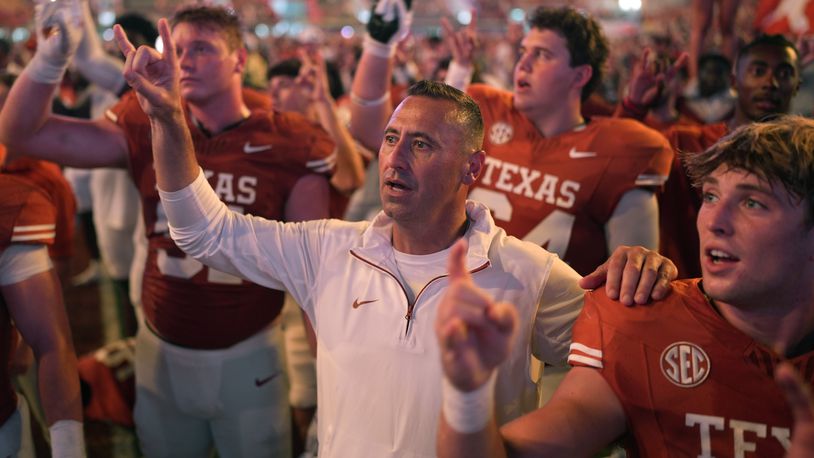 Texas head coach Steve Sarkisian, center, stands with players for the school song following their win over UTSA in an NCAA college football game in Austin, Texas, Saturday, Sept. 14, 2024. (AP Photo/Eric Gay)