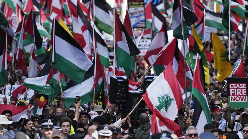 People march on the street as Pro-Palestinian supporters rally in Sydney, Sunday, Oct. 6, 2024. (AP Photo/Rick Rycroft)