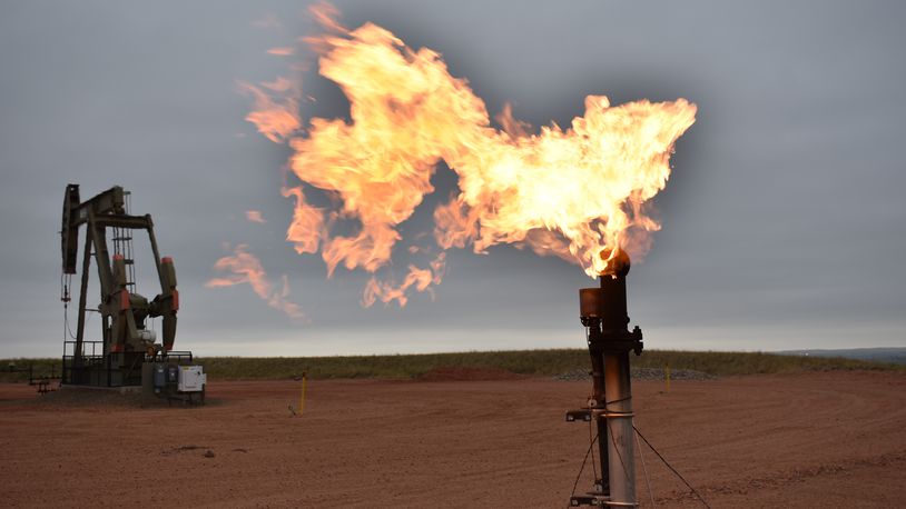 FILE - A flare burns natural gas at an oil well in Watford City, N.D., on Aug. 26, 2021. (AP Photo/Matthew Brown, File)