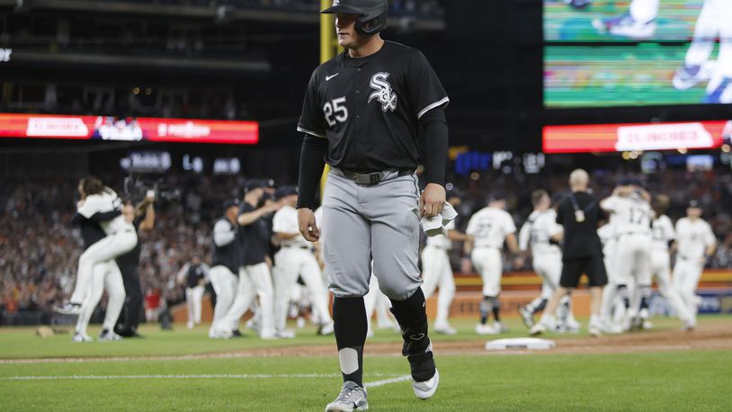 Chicago White Sox's Andrew Vaughn (25) walks off the field as the Detroit Tigers celebrate after making the playoffs after a win in a baseball game Friday, Sept. 27, 2024, in Detroit. (AP Photo/Duane Burleson)