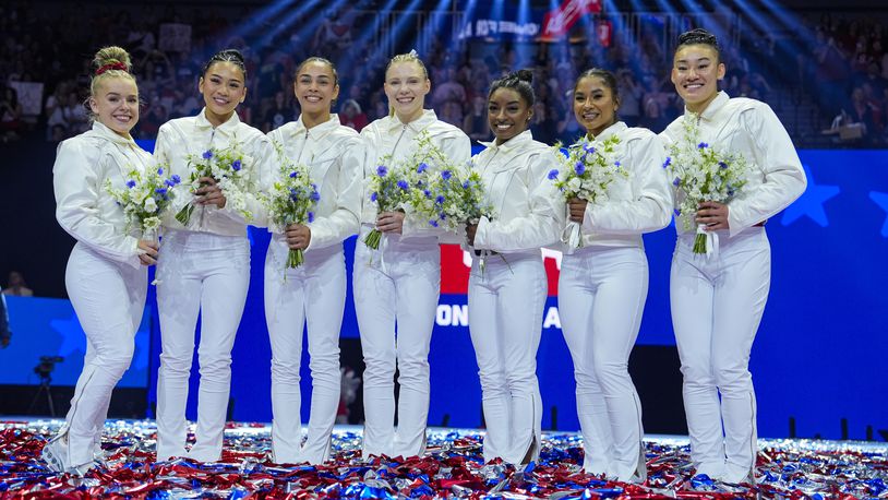 From left to right, Joscelyn Roberson, Suni Lee, Hezly Rivera, Jade Carey, Simone Biles, Jordan Chiles and Leanne Wong smile after they were named to the 2024 Olympic team at the United States Gymnastics Olympic Trials on Sunday, June 30, 2024, in Minneapolis. (AP Photo/Charlie Riedel)