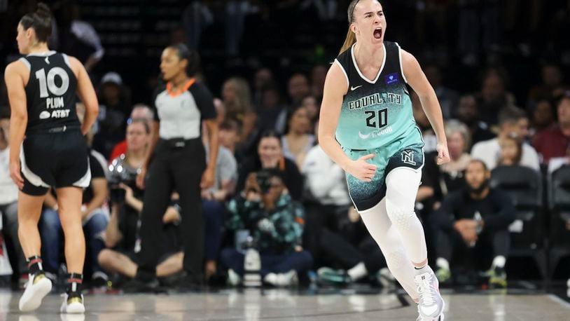 New York Liberty guard Sabrina Ionescu (20) reacts after a three-point- basket during the first half of a WNBA Semifinal game against the Las Vegas Aces, Sunday, Oct. 6, 2024, in Las Vegas. (AP Photo/Ian Maule)