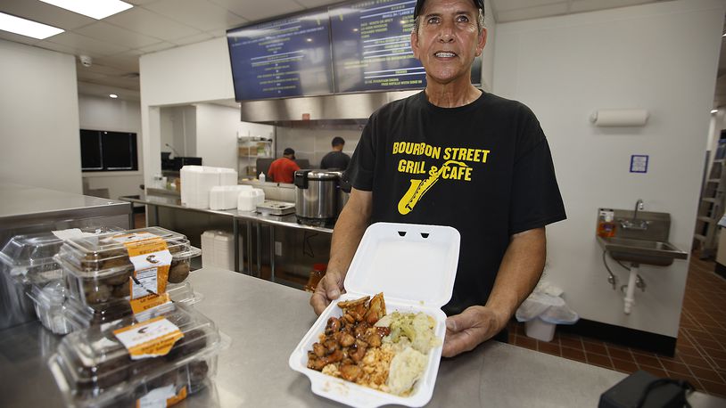 Hassan Abdalla, owner of the new Bourbon Street Grill & Cafe, with an bourbon chicken dinner Monday, July 8, 2024. BILL LACKEY/STAFF