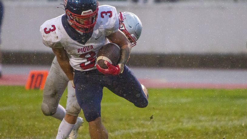 Piqua senior running back Jasiah Medley scores a touchdown in the rain against Troy in the first half Friday night at Troy. Jeff Gilbert/CONTRIBUTED