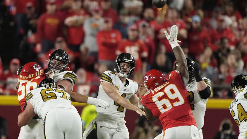 New Orleans Saints quarterback Derek Carr (4) throws over Kansas City Chiefs nose tackle Mike Pennel (69) during the first half of an NFL football game Monday, Oct. 7, 2024, in Kansas City, Mo. (AP Photo/Charlie Riedel)