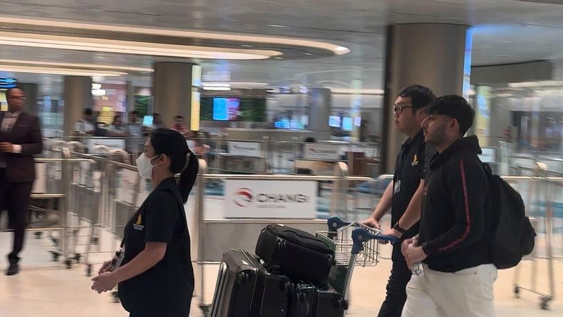 A passenger, with backpack at right, arrives from Bangkok at a Singapore airport Wednesday, May 22, 2024. A Singapore Airlines flight from London's Heathrow airport to Singapore was diverted and landed in stormy weather in Bangkok on Tuesday. (AP Photo)