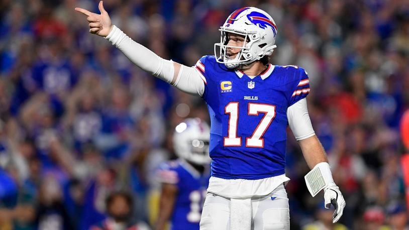 Buffalo Bills quarterback Josh Allen (17) signals for a first down during the first half of an NFL football game against the Jacksonville Jaguars, Monday, Sept. 23, 2024, in Orchard Park, NY. (AP Photo/Adrian Kraus)