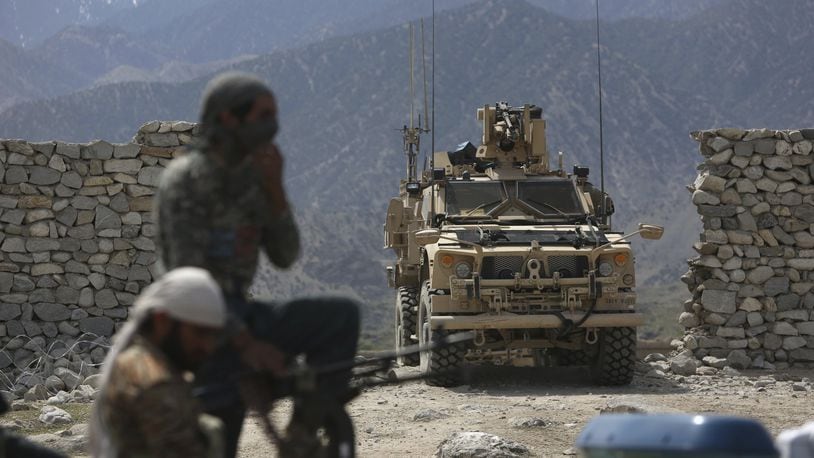 In this April 17, 2017 file photo, U.S. forces and Afghan security police are seen in Asad Khil near the site of a U.S. bombing in the Achin district of Jalalabad, east of Kabul, Afghanistan. Behind the detail-scarce rhetoric of the new Afghanistan strategy, elements of President Donald Trump’s broader approach to foreign conflicts emerge: secret military plans, no “nation-building” and a reliance on regional players to squeeze wayward nations and extremist groups. (AP Photo/Rahmat Gul, File)