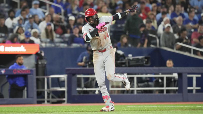 Cincinnati Reds' Elly De La Cruz celebrates as he rounds third base after hitting a home run during the eighth inning of a baseball game against the Toronto Blue Jays in Toronto on Wednesday, Aug. 21, 2024. (Chris Young/The Canadian Press via AP)